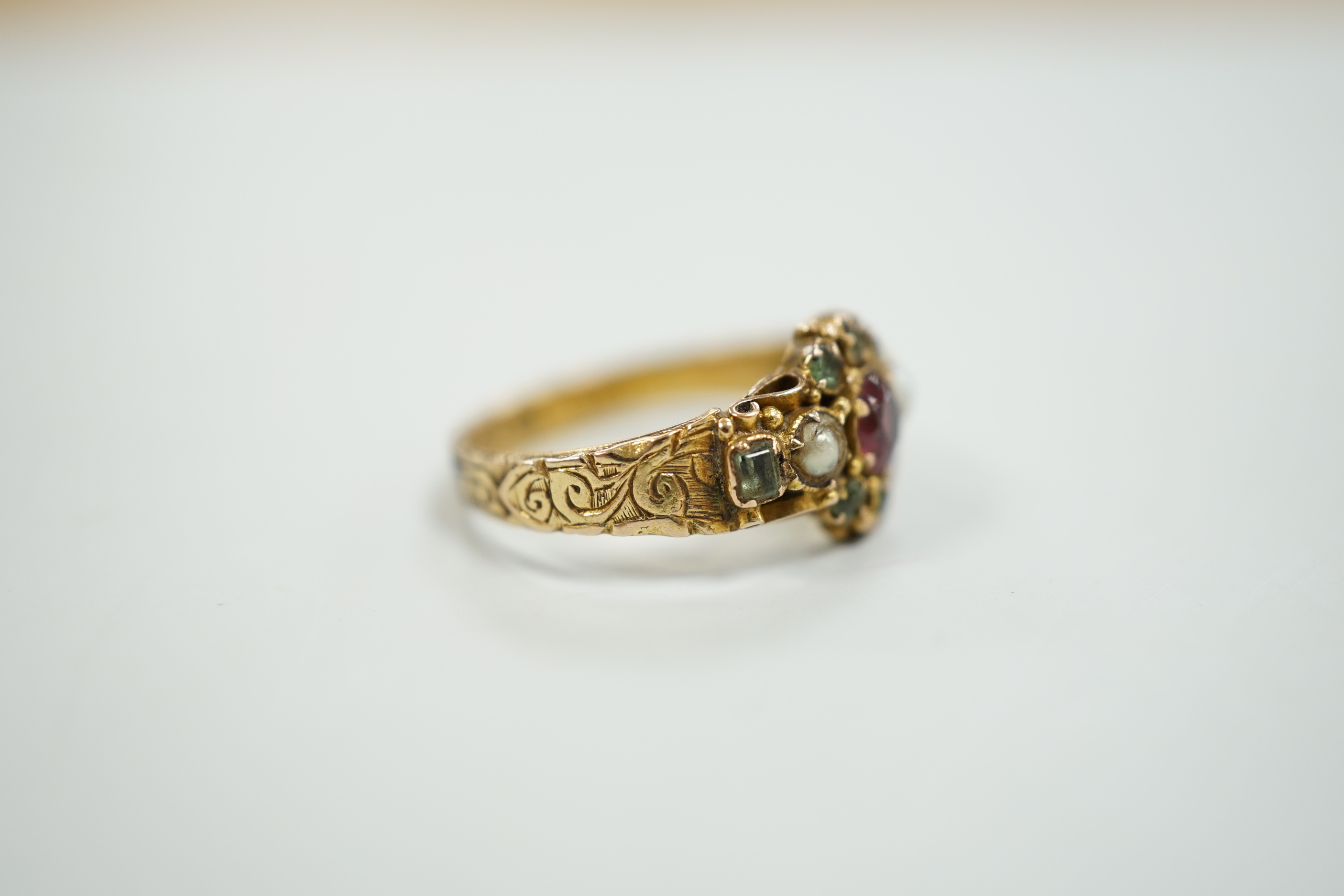 A late Victorian 15ct gold, ruby?, emerald and seed pearl cluster set dress ring, size K, gross weight 2.6 grams, with engraved shank.